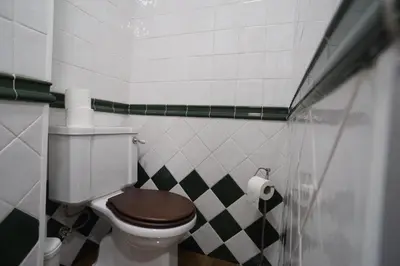 a bathroom with a toilet with a wooden seat at Modern house - air cond, free parking, breakfast, by Porto with Love LDA in Vila Nova de Gaia