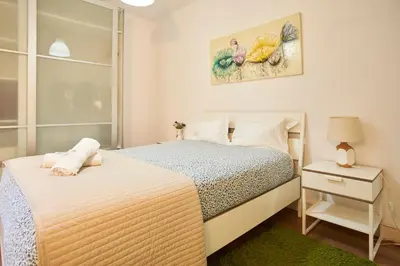 a small bedroom with two beds and a night stand at Riverside (with 3 Bedrooms) by JC in Porto
