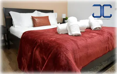 a bedroom with a large bed with a red blanket at Riverside (with 3 Bedrooms) by JC in Porto
