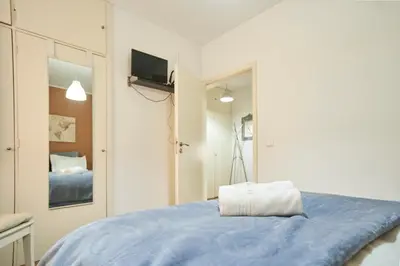 a bedroom with a blue bed and a mirror at Riverside (with 3 Bedrooms) by JC in Porto