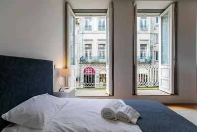a bedroom with a bed with two towels on it at Santa Catarina Downtown I in Porto