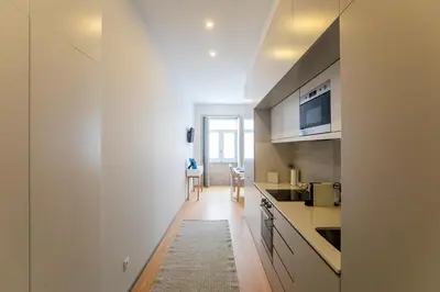 a kitchen with white counters and a counter top at Santa Catarina Downtown II in Porto