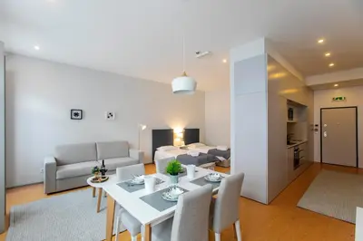 a living room with a white table and chairs at Santa Catarina Downtown II in Porto