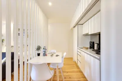 a kitchen with a white table and white chairs at January's 31 Studio by DA'HOME in Porto
