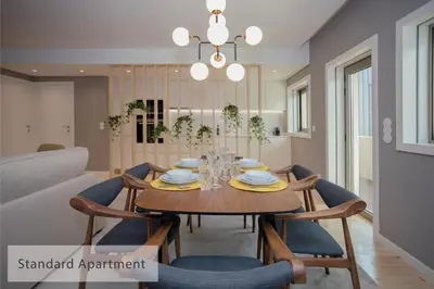 a dining room with a wooden table and chairs at Alegria Residence in Porto