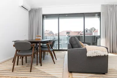 a living room with a table and chairs and a couch at VIVA In the MOOD in Porto
