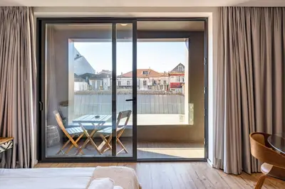 a bedroom with a sliding glass door leading to a patio at VIVA In the MOOD in Porto