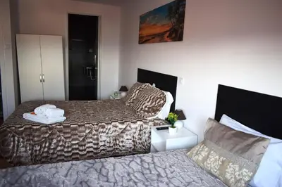 a hotel room with two beds and a bedskirts at Guest House Henrique VIII in Porto
