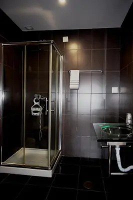 a bathroom with a shower and a sink at Guest House Henrique VIII in Porto