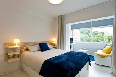 a bedroom with a large bed and a window at L&M Apartment in Porto