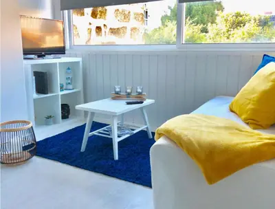 a bedroom with a white table and a television at L&M Apartment in Porto
