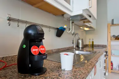 a juicer sitting on a kitchen counter next to a sink at L&M Apartment in Porto