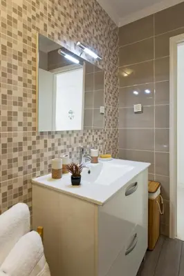 a bathroom with a sink and a mirror at L&M Apartment in Porto