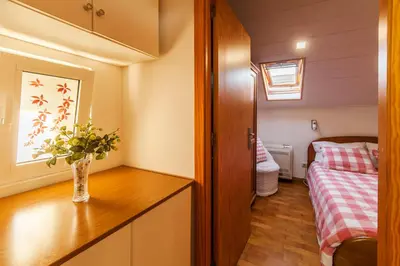 a small room with a bed and a vase on a table at Bairro Alegre, Casa do Porto in Porto