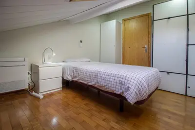 a bedroom with a bed and a wooden floor at Bairro Alegre, Casa do Porto in Porto