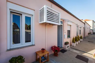 a building with an air conditioner on the side of it at Bairro Alegre, Casa do Porto in Porto