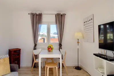 a small dining room with a white table and chairs at Casa de Gaia in Vila Nova de Gaia