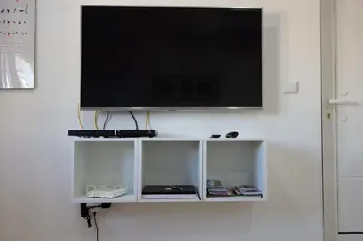 a flat screen tv hanging on a white wall at Casa de Gaia in Vila Nova de Gaia