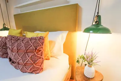 a bedroom with a bed with two lamps and a vase at Macário Cosy Loft in Porto