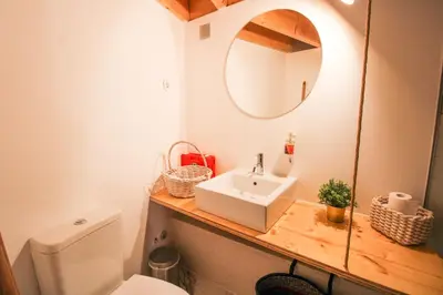 a bathroom with a sink and a mirror and a toilet at Macário Cosy Loft in Porto