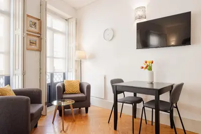 a living room with a black table and chairs at CASA JOY Boavista apartment in Porto