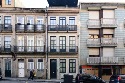 a tall building with windows and balconies on a street at CASA JOY Boavista apartment in Porto