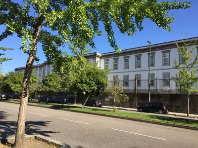 a large white building with cars parked in front of it at CASA JOY Boavista apartment in Porto