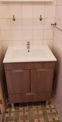 a bathroom with a white sink and a shower at City Heart Rooms in Porto