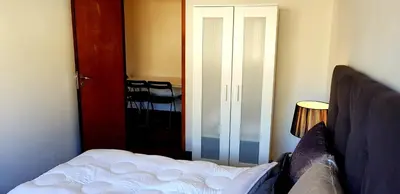 a bedroom with a bed and a sliding door at City Heart Rooms in Porto