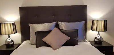 a bedroom with a large bed with two lamps at City Heart Rooms in Porto
