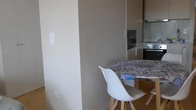 a kitchen with a table and chairs in a room at The Porto Way in Porto
