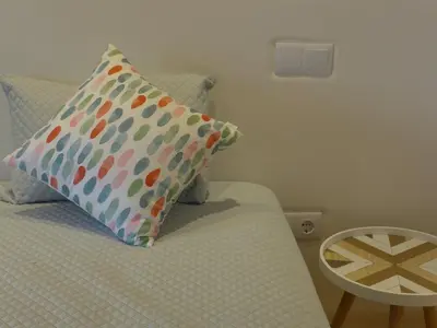 a bedroom with a bed with a pillow and a table at The Porto Way in Porto