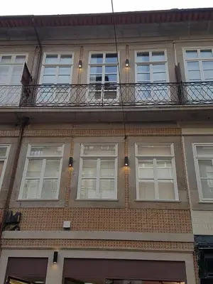 a brick building with windows and a balcony at The Porto Way in Porto