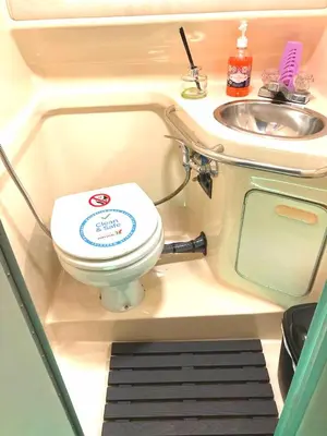 a small bathroom with a toilet and a sink at SLEEPBOAT Barco Hotel in Porto