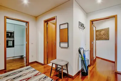 a living room with a chair and a table at Charming Bonfim Penthouse in Porto