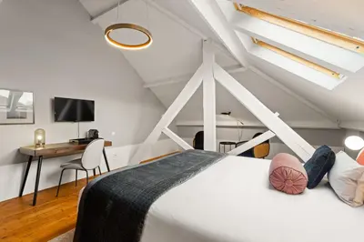 a bedroom with a white bed and a desk at The White Box Boutique House in Porto