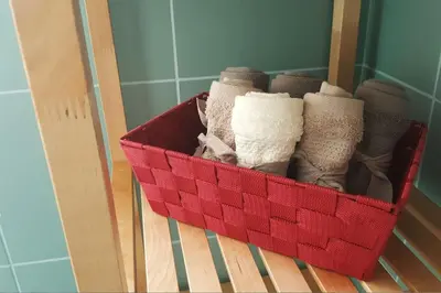 a red basket of socks on a wooden shelf at NiP Apartment | Porto City Center Near All Sights in Porto