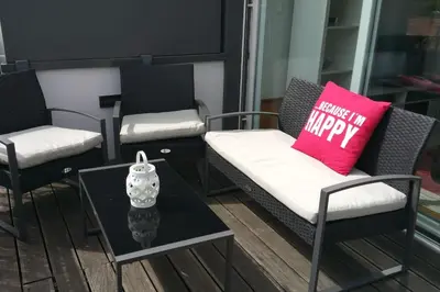 a room with three chairs and a table with a pink pillow at NiP Apartment | Porto City Center Near All Sights in Porto