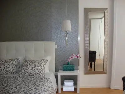 a bedroom with a bed and a mirror and a table at Be Happy in Porto in Porto