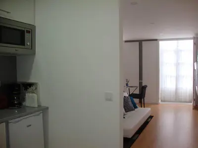a living room with a couch and a microwave at Be Happy in Porto in Porto