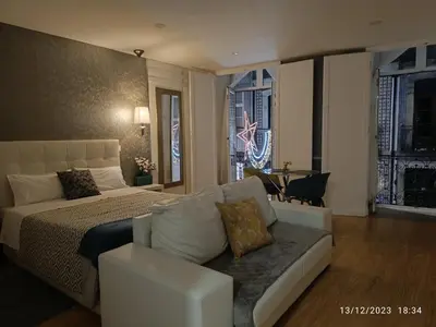 a bedroom with a bed and a couch and windows at Be Happy in Porto in Porto
