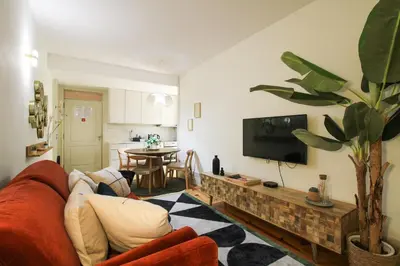 a living room with a red couch and a tv at Douro Divine in Porto