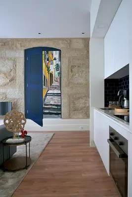 a kitchen with a blue door in a room at Mayor's Apartments in Porto