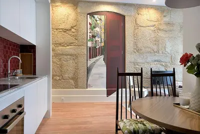 a kitchen with a table and chairs in a room at Mayor's Apartments in Porto