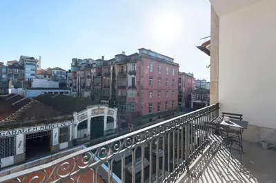 a living room with a couch and a tv at Tripas-Coração, Sá da Bandeira in Porto