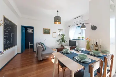 a dining room and living room with a table and chairs at SP199 Flat in Porto