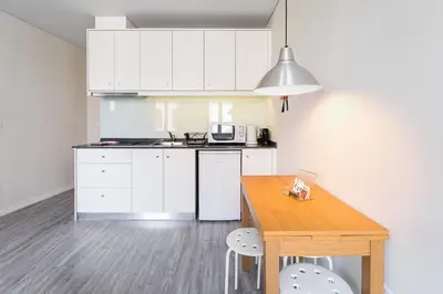 a white bathroom with a sink and a shower at General Torres Apartments by Lisbeyond in Vila Nova de Gaia