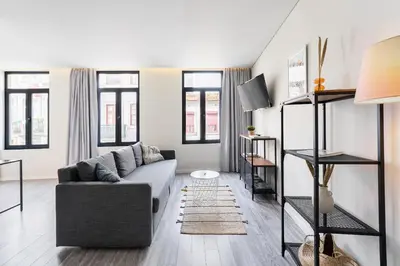 a living room with a couch and some windows at General Torres Apartments by Lisbeyond in Vila Nova de Gaia