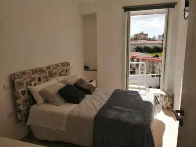 a bedroom with a bed and a large window at Casa Ventuzelo in Porto