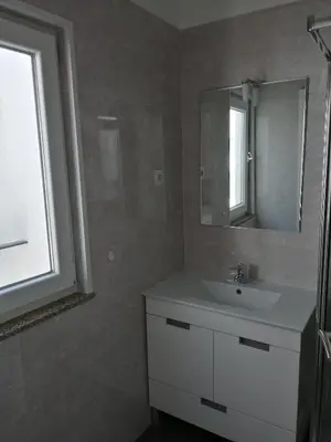 a bathroom with a white sink and a mirror at Casa Ventuzelo in Porto